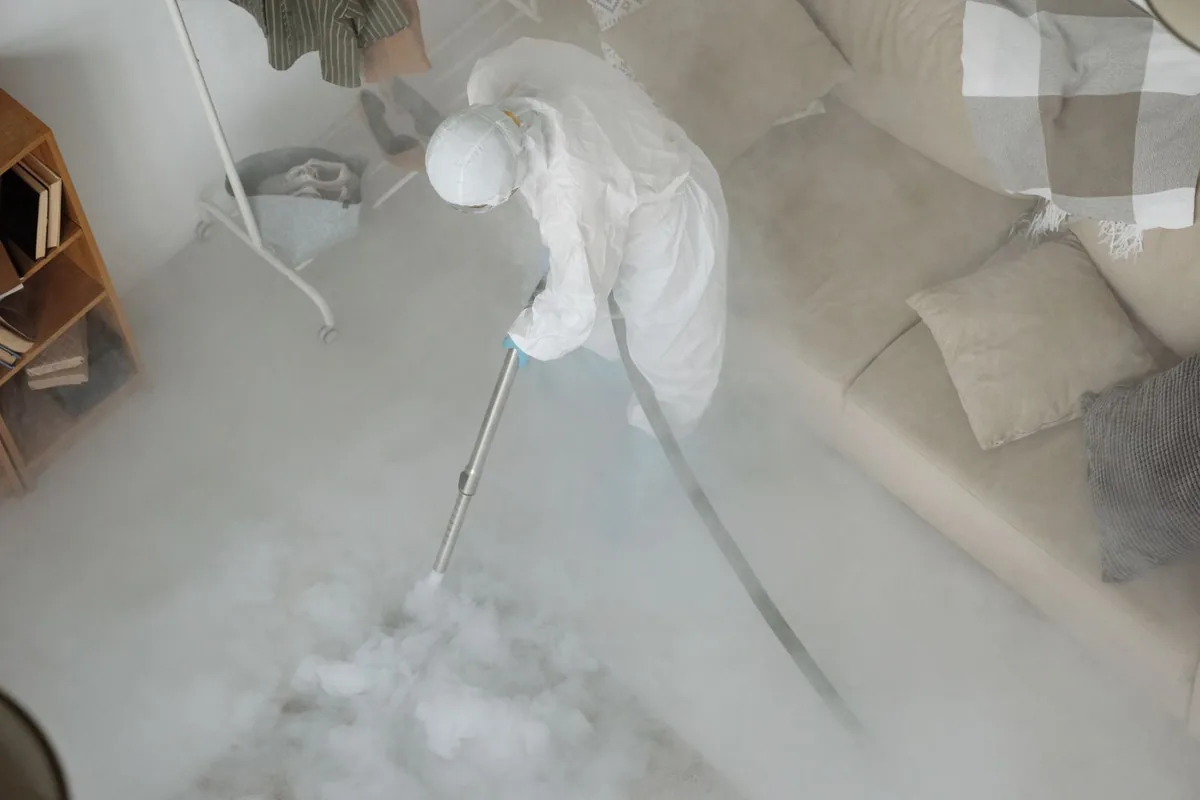 Biohazard cleanup technician in protective equipment, Lexington, MS